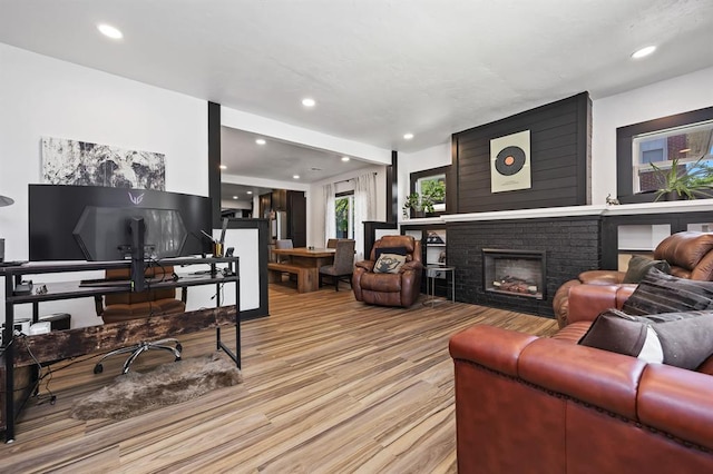 living room featuring a brick fireplace