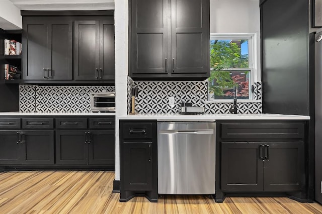 kitchen with dishwasher, decorative backsplash, and light hardwood / wood-style flooring