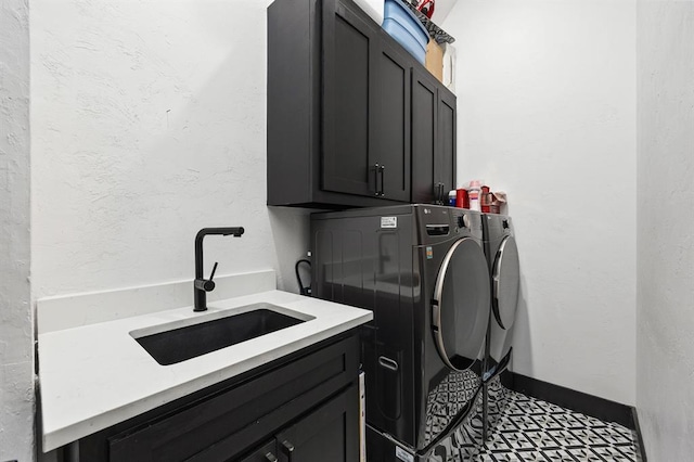 laundry area with cabinets, separate washer and dryer, and sink