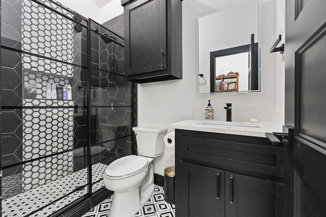 bathroom with vanity, a shower with shower door, and toilet