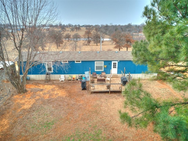 back of property with an outdoor living space and a wooden deck