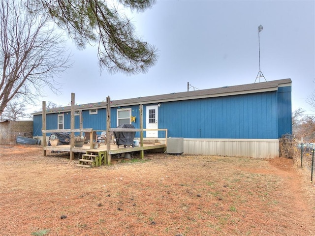 rear view of property featuring a wooden deck and central air condition unit