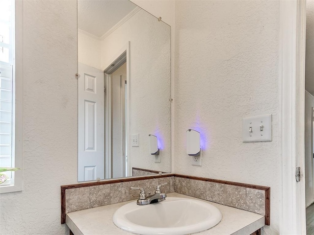 bathroom featuring vanity and crown molding