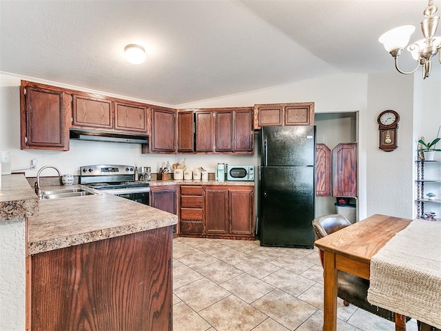 kitchen with vaulted ceiling, pendant lighting, sink, stainless steel range with electric stovetop, and black refrigerator