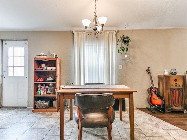 dining space with tile patterned flooring and a notable chandelier