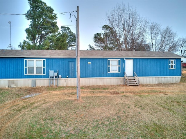 rear view of house featuring a lawn