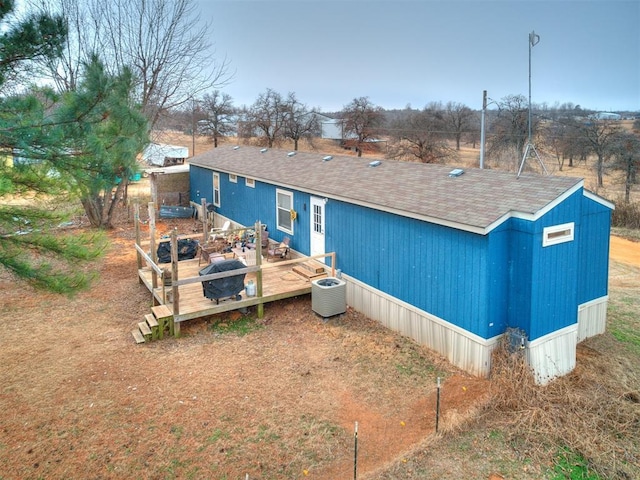 rear view of house featuring a deck and central air condition unit