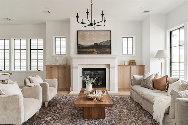 living room featuring an inviting chandelier and hardwood / wood-style floors