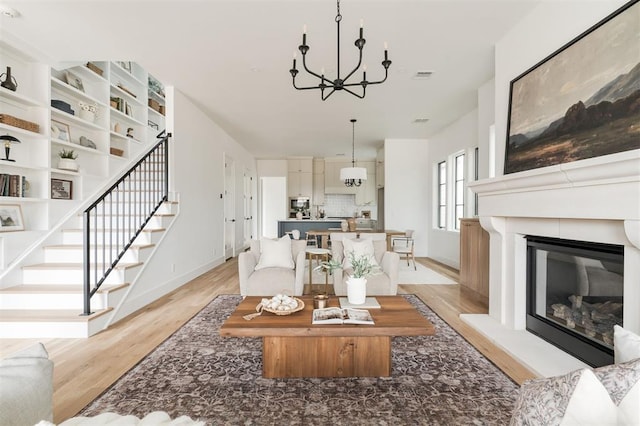 living room featuring light hardwood / wood-style flooring and a chandelier