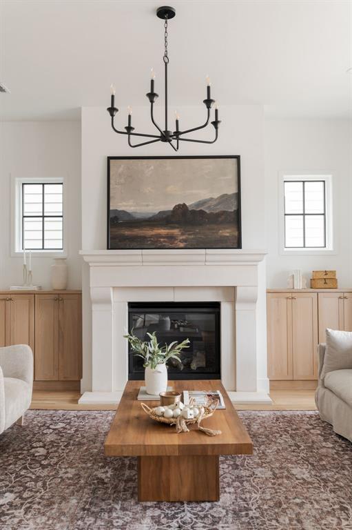 living room featuring an inviting chandelier and light wood-type flooring