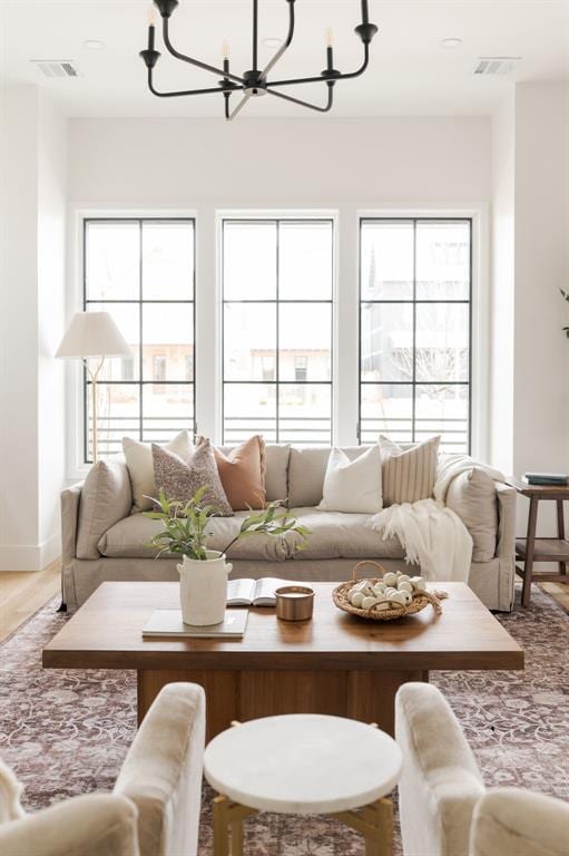 living room with hardwood / wood-style flooring and a chandelier