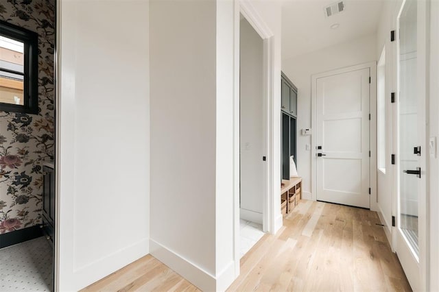 hallway with light hardwood / wood-style flooring