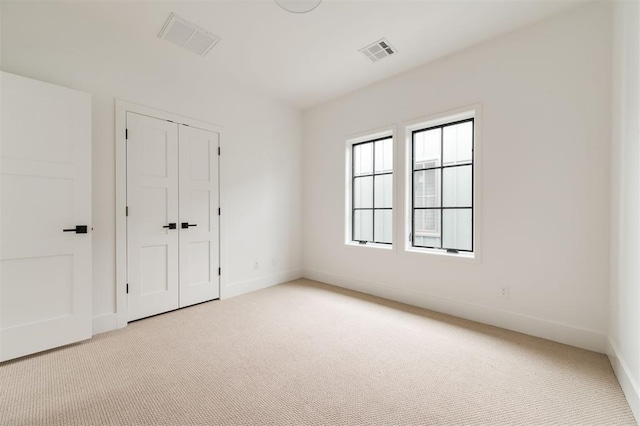 spare room with light carpet