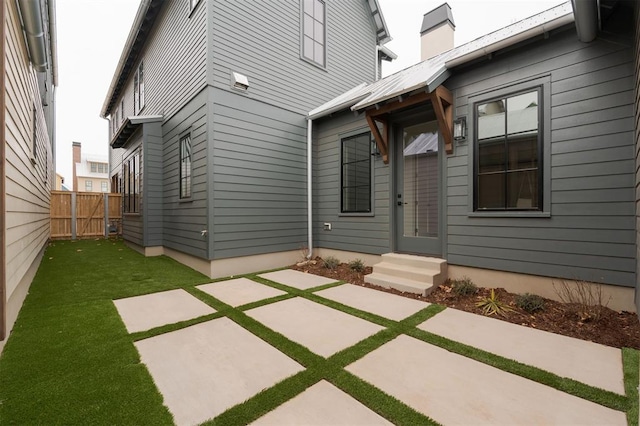 rear view of property with a lawn and a patio