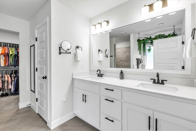 bathroom with vanity, tile patterned flooring, and walk in shower