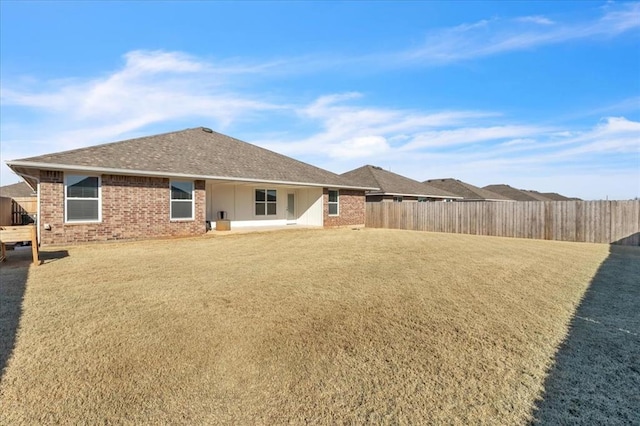 rear view of property with a yard