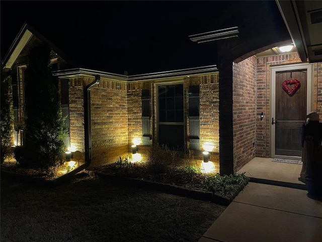 view of exterior entry at twilight