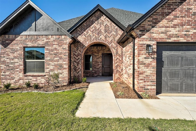 property entrance featuring a yard and a garage