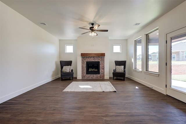 interior space featuring ceiling fan, dark hardwood / wood-style floors, and a fireplace