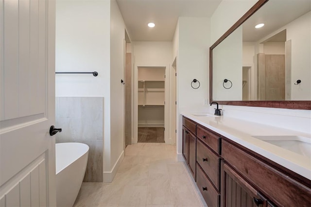 bathroom with independent shower and bath, tile patterned floors, and vanity