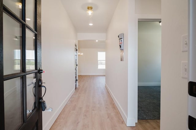 corridor with light wood-type flooring