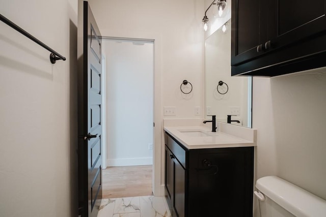 bathroom with toilet and vanity