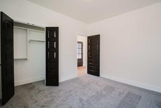 unfurnished bedroom with a closet and carpet flooring