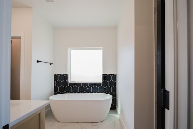 bathroom featuring vanity and a tub