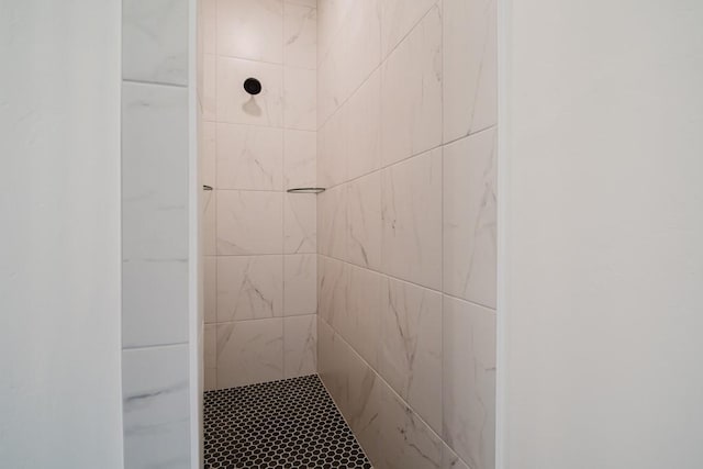 bathroom with a tile shower