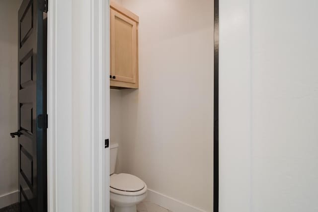 bathroom featuring toilet and tile patterned flooring