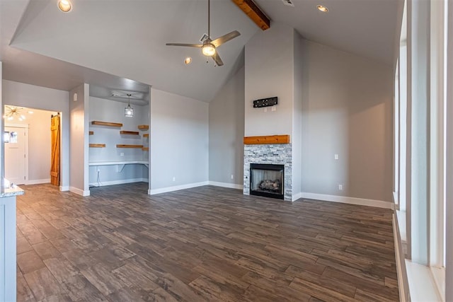 unfurnished living room with dark wood-type flooring, beamed ceiling, a fireplace, ceiling fan, and high vaulted ceiling