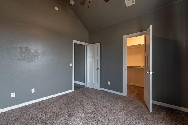 unfurnished bedroom featuring carpet floors, a spacious closet, and high vaulted ceiling