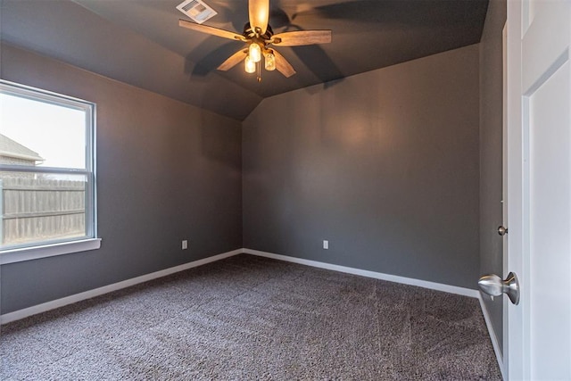 carpeted empty room with ceiling fan and vaulted ceiling