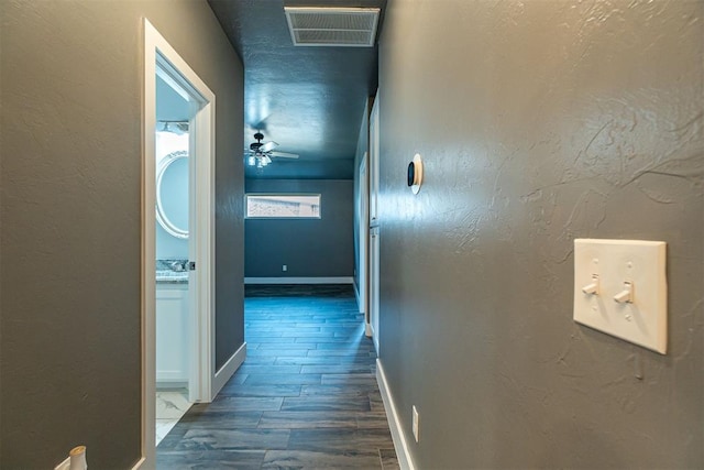 corridor with sink and dark hardwood / wood-style floors