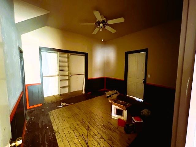 interior space with ceiling fan and dark hardwood / wood-style flooring