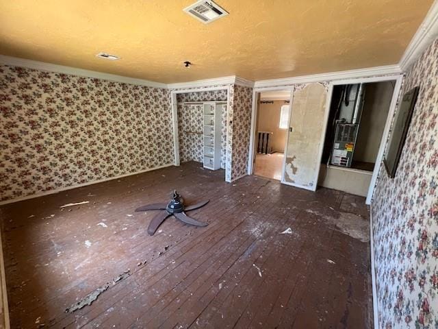 interior space with dark hardwood / wood-style floors and crown molding