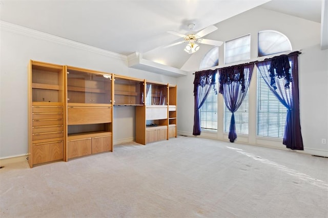 unfurnished living room with ornamental molding, lofted ceiling, light carpet, and ceiling fan