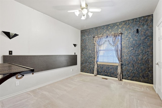 interior space with light colored carpet and ceiling fan