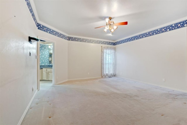 empty room featuring ornamental molding, carpet flooring, and ceiling fan