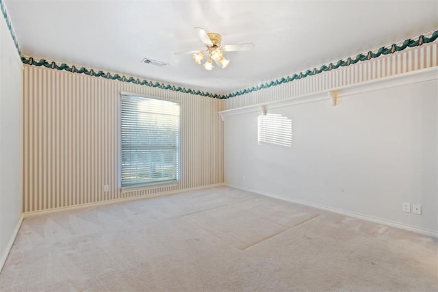 unfurnished room featuring ceiling fan and light carpet