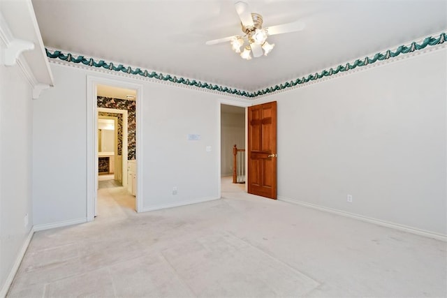 spare room with ceiling fan and light colored carpet