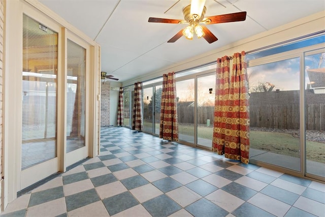 spare room featuring ceiling fan and a healthy amount of sunlight