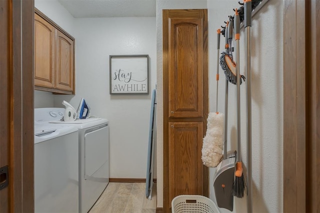 washroom featuring cabinets and separate washer and dryer