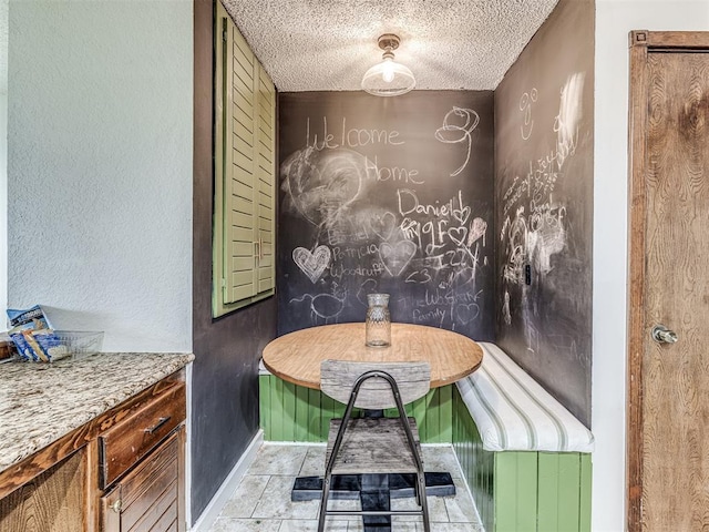 interior space featuring baseboards and a textured ceiling