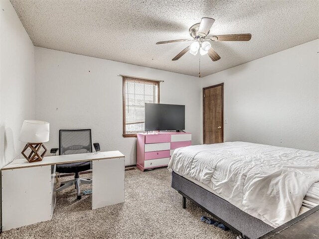 carpeted bedroom featuring a textured ceiling and a ceiling fan