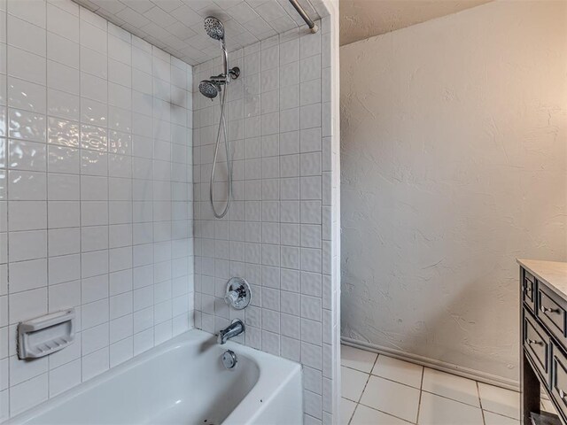 full bath with tile patterned floors, a textured wall, baseboards, and shower / bath combination