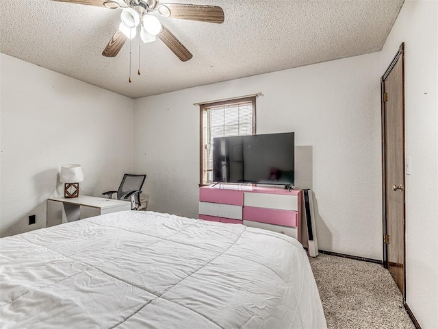 bedroom with a ceiling fan, a textured ceiling, carpet flooring, and a textured wall