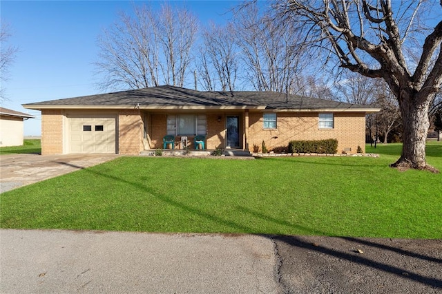 ranch-style home featuring a garage, a front yard, and covered porch