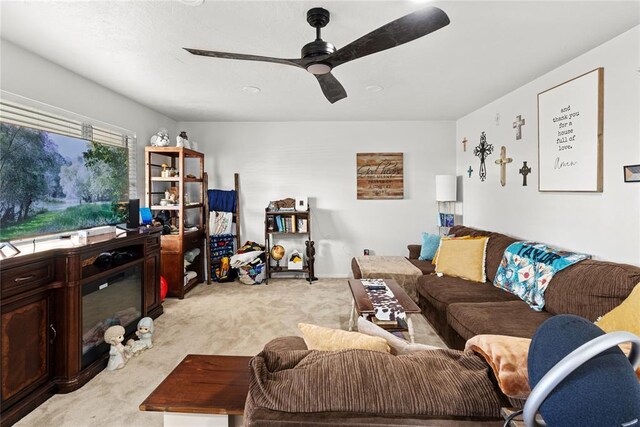 carpeted living room featuring ceiling fan