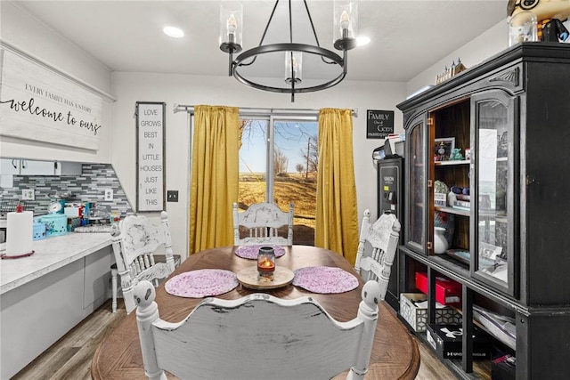 dining area with a chandelier and light hardwood / wood-style floors